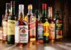 Assorted whiskey bottles arranged on a wooden surface