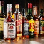Assorted whiskey bottles arranged on a wooden surface