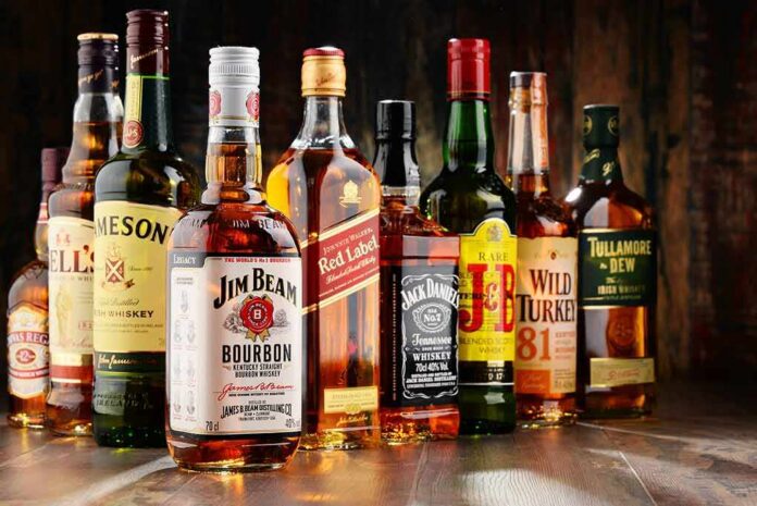 Assorted whiskey bottles arranged on a wooden surface