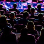 Audience seated in a theater or conference hall