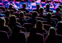 Audience seated in a theater or conference hall