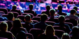 Audience seated in a theater or conference hall