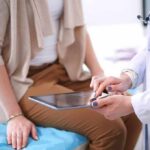 doctor showing patient information on a tablet