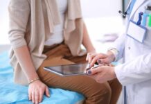 doctor showing patient information on a tablet