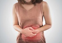 Everyone Has 3 Hemorrhoids! woman holding her stomach in pain with digestive graphic overlay