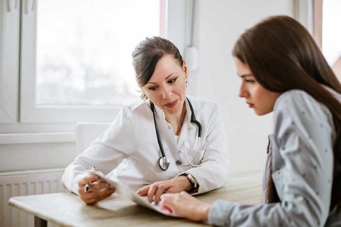 Doctor consulting a patient at a desk