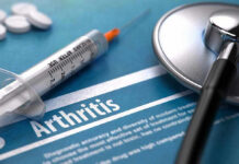 Syringe and stethoscope on arthritis document