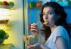 Late Bites, Liver Damage Warning Woman snacking at an open refrigerator