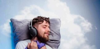 Man sleeping with headphones on a pillow