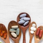 Assorted dietary supplements on wooden spoons