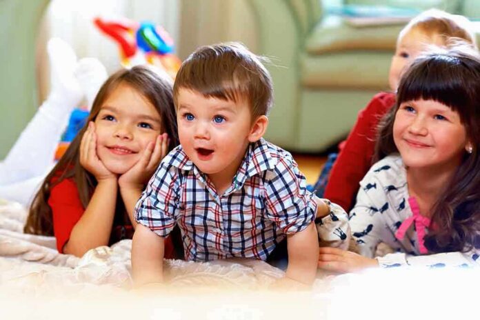 shutterstock_125877587 A group of children enjoying playtime indoors, displaying joyful expressions