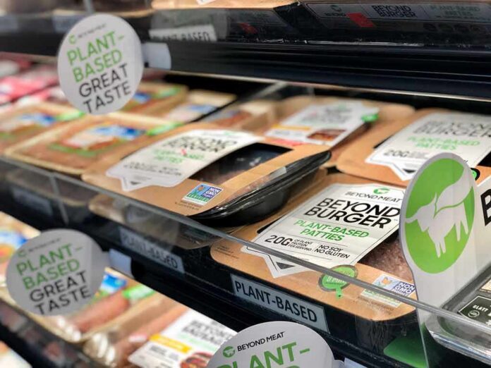 Plant-based burger patties in a grocery store cooler
