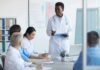 Doctor leading a meeting with medical team in a conference room