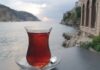 Glass of tea on a saucer by the seaside