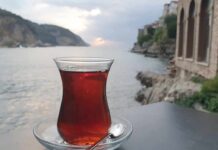 Glass of tea on a saucer by the seaside