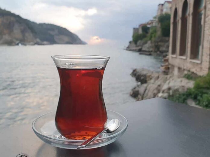Glass of tea on a saucer by the seaside