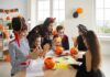 Johns Hopkins Issues Halloween Alarm children in Halloween costumes doing crafts at a table