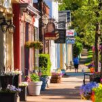 Charming small-town street with colorful storefronts and flowers