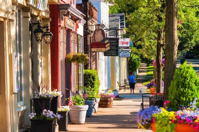 Charming small-town street with colorful storefronts and flowers