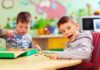 Baby Teeth Expose Startling Autism Link Two young boys playing with colorful shapes at a classroom table