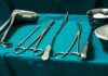 Surgical instruments arranged on a teal drape