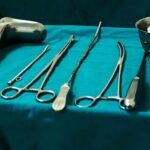 Surgical instruments arranged on a teal drape