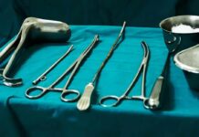 Surgical instruments arranged on a teal drape