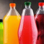 Assorted colorful plastic beverage bottles with condensation